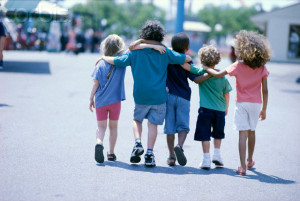 Children Walking with Arms Around Each Other